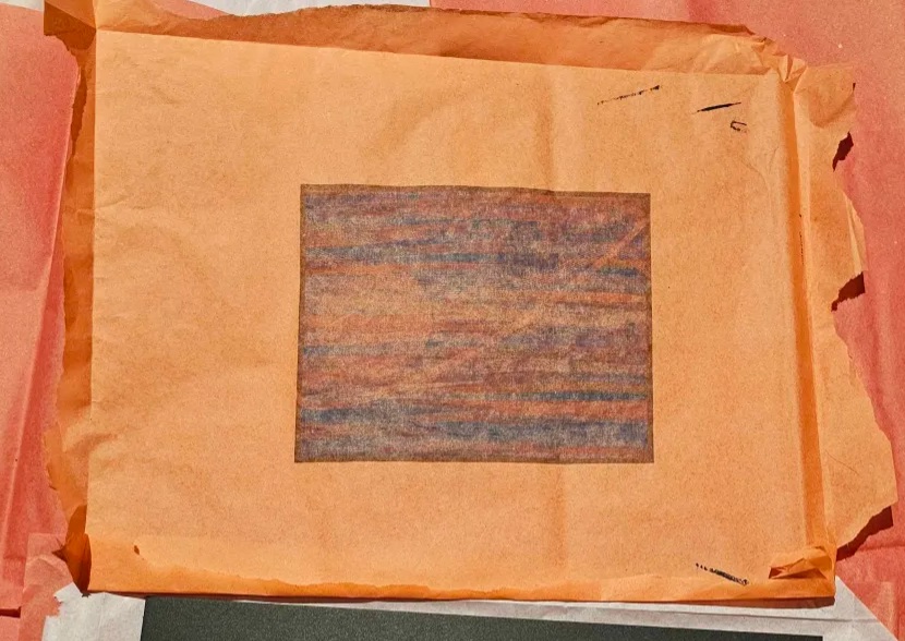 Processing piece experimentally printed on orange tissue paper